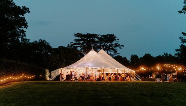Bignor Park Weddings Greek Loggia Formal Gardens reception at night with band 1 2700x1536 1 768x437