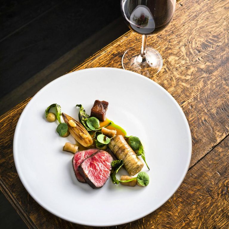 dry aged beef sirloin braised ox tongue bone marrow candied aubergine tomato essence marinated aubergine bbq sea beet confit shallot 03052024081721 768x768